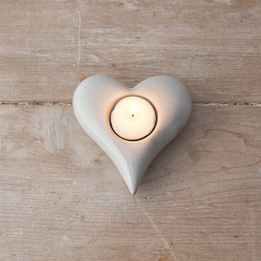 A simple and elegant ceramic t-light holder with a natural cream glaze and rustic finish. 