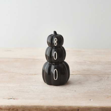 A chic pumpkin stack in black with a BOO slogan. A stylish accessory to display around the home this season. 
