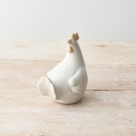 A rustic chicken ornament with a natural glaze and raw detailing. 