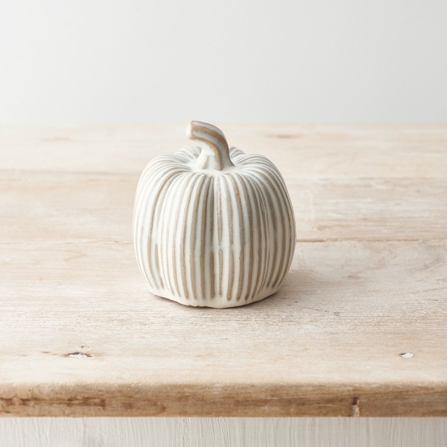 A classic pumpkin ornament with a ribbed finish and natural reactive glaze. A timeless decoration with a rustic finish. 