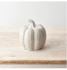 A stylish and unique ceramic pumpkin with a ribbed surface and reactive glaze finish.