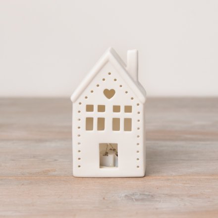 A ceramic house light up decoration with cut out design and heart detailing. 