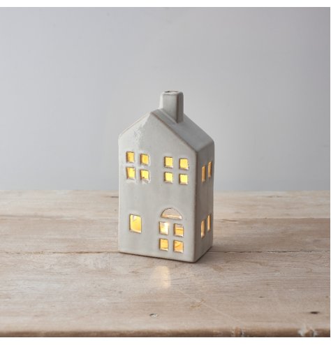 A ceramic led house with rustic shabby chic finish and cut out design. 