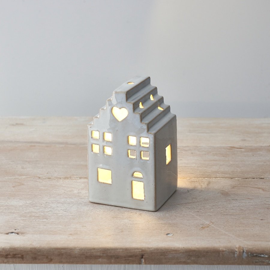 A stylish and striking light up ceramic house with led tea light, stepped roof design & cut out windows, door and heart.