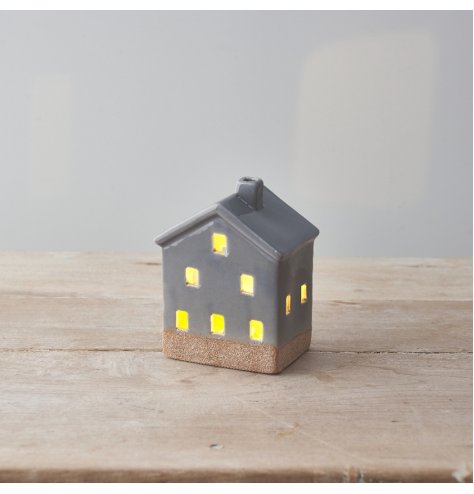 A stylish ceramic house with cut out details, contrasting base and stylish grey colour scheme.