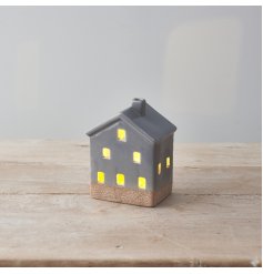 A stylish ceramic house with light up feature, on trend grey design, cut out details with contrasting base. 