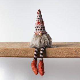 A shelf sitting fabric gnome with cute striped legs, knitted patterned hat and fluffy beard. 