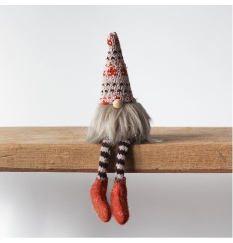 A charming fabric gonk with fluffy beard, bead nose and cute striped knitted legs and patterned hat. 