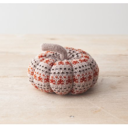 A cute, soft pumpkin featuring a patterned knitted fabric design. 