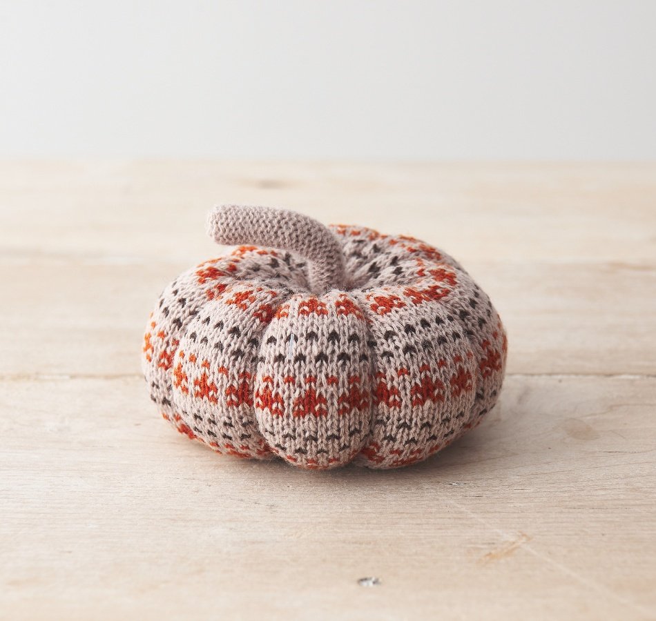 A decorative fabric pumpkin featuring a stylish patterned knit fabric design. 