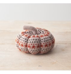 A cute, soft pumpkin featuring a patterned knitted fabric design. 