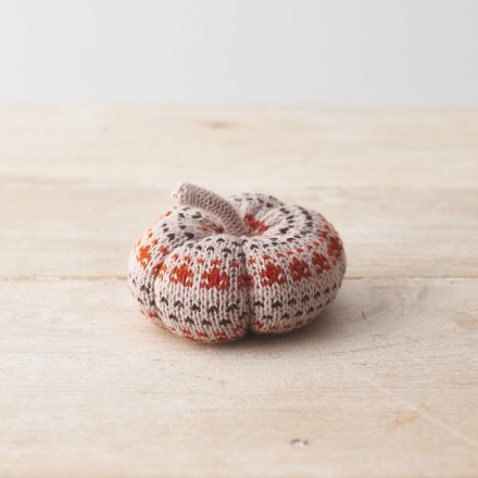 A beautifully crafted knitted pumpkin ornament in earthy orange and natural colours. 