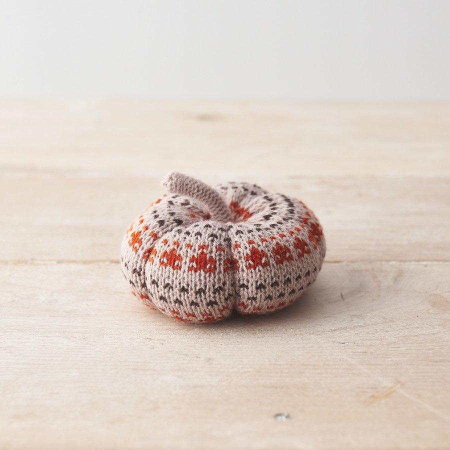 A chic and unique knitted pumpkin decoration in earthy natural and burnt orange colours.