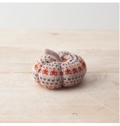 A beautifully crafted knitted pumpkin ornament in earthy orange and natural colours. 