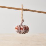 Fall in love with this adorable knitted pumpkin in burnt orange and earthy tones. Complete with a jute string hanger.