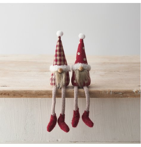 An assortment of 2 shelf sitting gonks featuring long dangly legs, patterned fabric and fluffy beards. 