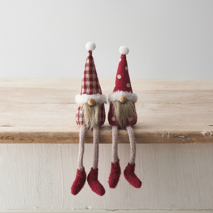 An assortment of 2 shelf sitting gonks, each with a fluffy beard, bead nose and gingham/polka dot patterned fabric. 