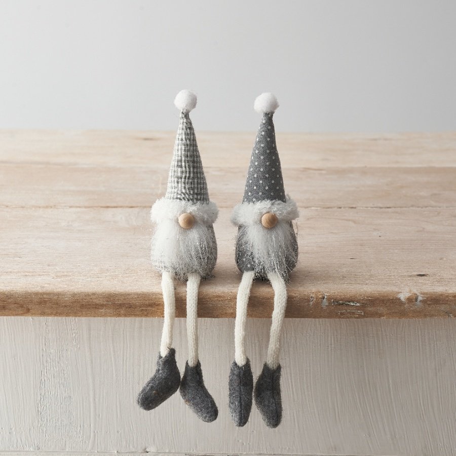 An assortment of 2 sitting gonk decorations featuring long dangly legs, fluffy beard and patterned grey fabric. 