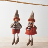 An assortment of 2 knitted dolls in chic burnt orange autumnal outfits.