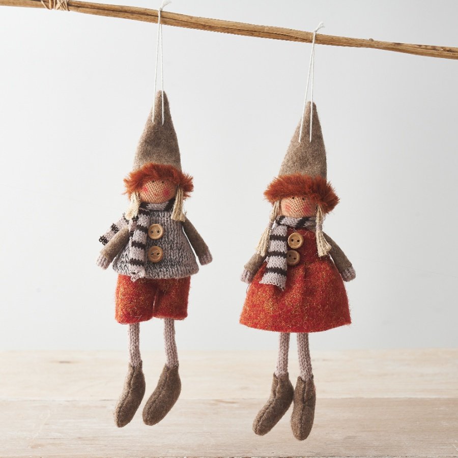 An assortment of 2 charming doll hangers. Each is wearing richly coloured autumnal clothes in earthy tones.