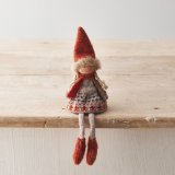 A charming knitted doll decoration dressed in Autumnal clothes in rich burnt orange hues.
