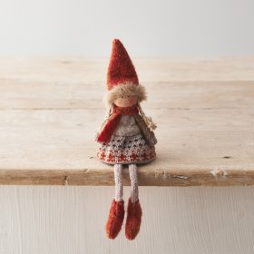 A charming knitted doll decoration with richly coloured seasonal details including a knitted skirt and faux fur trim hat