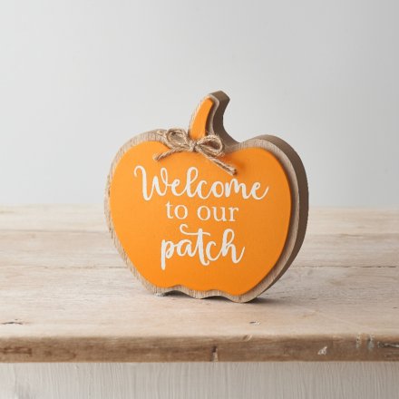 A charming and unique pumpkin shaped sign reading 'Welcome to our Patch'. 