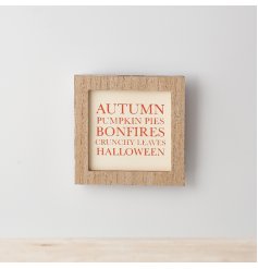 A wooden framed sign with a Halloween/ Autumn inspired text in a seasonal orange tone. 