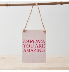 A colourful mini metal sign with "darling, you are amazing" message in red on a pretty pink background. 