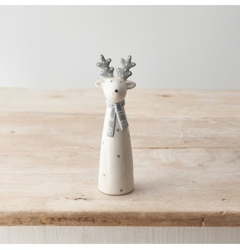 A chic grey and white ceramic reindeer ornament with a polka dot pattern and striped scarf.