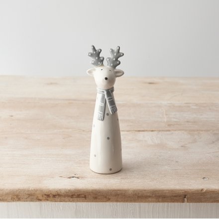 A stylish grey and white ceramic reindeer ornament with a patterned scarf and polka dot design. 