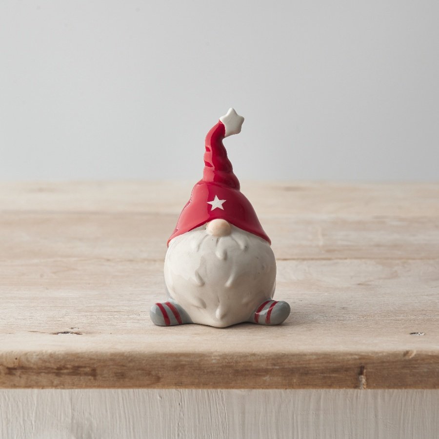 A characterful ceramic gonk ornament with a unique twisted hat, textured beard and star motif. 