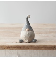 A chic grey and white ceramic gonk decoration with a polka dot hat. 
