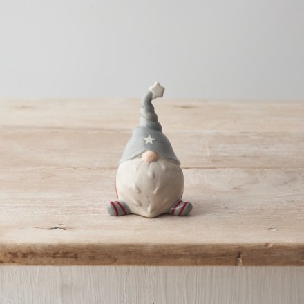 A chic ceramic gonk decoration with a star hat and stripy legs.