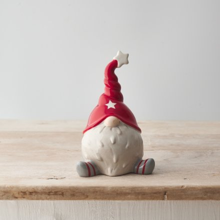 A unique and stylish sitting ceramic gonk decoration with a festive red hat and star detailing. 