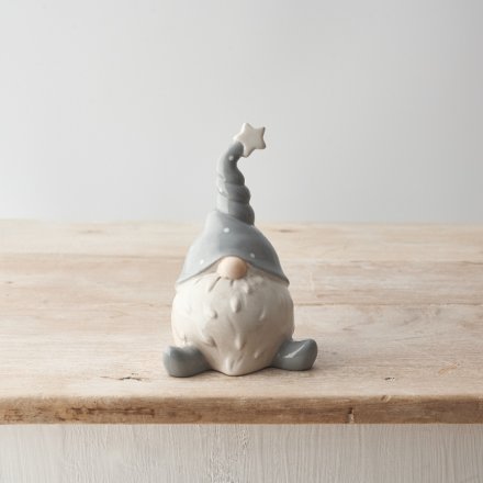 A charming ceramic gonk ornament in grey and white with a twisted star hat. 