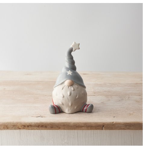 A chic ceramic gonk ornament with red and grey stripy legs and a cute twisted hat. 