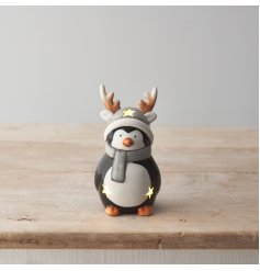 A cute ceramic penguin ornament with a glossy glaze and warm glow LED lights. 