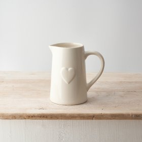 A chic ceramic jug with an embossed heart. A classic gift item and functional interior accessory.
