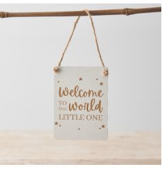 A cute mini metal sign with "Welcome to the world little one" message in gold with gold star details. 