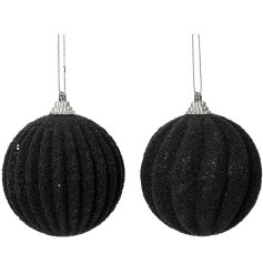 An assortment of 2 luxury baubles decorated with small black glitter beads. The assortment includes a wave and stripe 