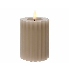 A chic natural earthy coloured wax candle with a carved design and warm glow LED flame. 