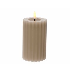 A chic LED candle with a warm glow wick. A stylish ribbed design with a wax, ribbed texture. 