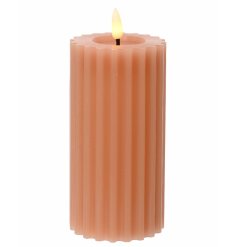 A pretty peach coloured wax candle with ribbed detailing and a dipped centre. Complete with warm glow LED flame. 