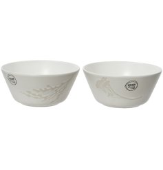 An assortment of 2 stoneware bowls with a matte glaze and stylish flower and leaf design. 