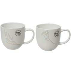 An assortment of 2 mugs in neutral colours, each with a delicate leaf and flower pattern. 