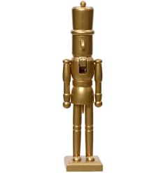 A contemporary wooden nutcracker painted with a stylish gold shiny finish.