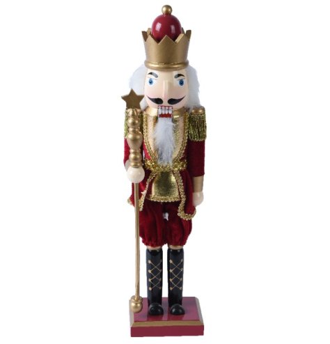 A magical nutcracker decoration with star topped wand and ornate costume. 