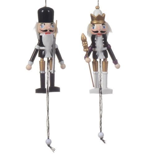 An assortment of 2 wooden nutcracker decorations, painted in chic monochrome colours with gold detailing.