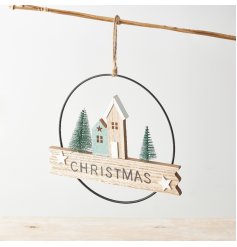 A stylish hanging wreath sign with a charming woodland street scene and artificial trees. 